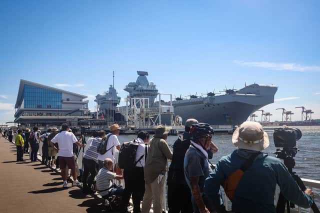 Onlookers line up to see off HMS Prince of Wales from Tokyo