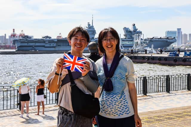 Onlookers line up to see off HMS Prince of Wales from Tokyo