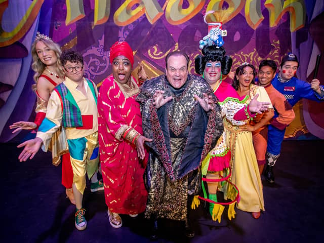 Pictured: Cast of the Aladdin including Rustie Lee as Genie and Shaun Williamson