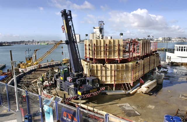 Steel fabrications - being brought in by barge and crane, as the Spinnaker tower starts to rise from its foundations at Gunwharf Quays, 
PICTURE: MICHAEL SCADDAN 6/3/03