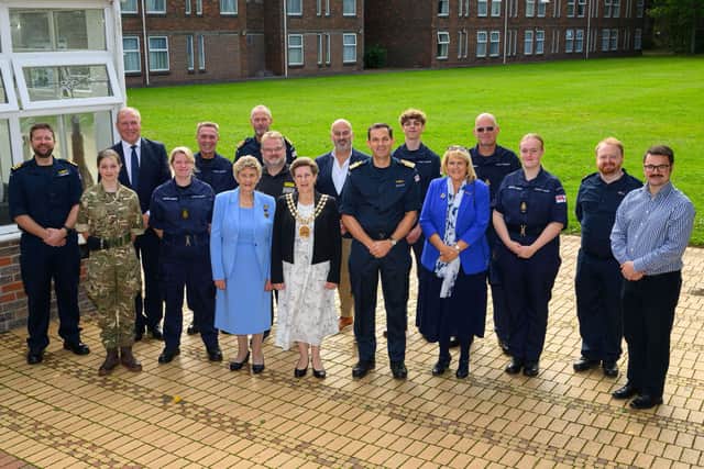 Charity representatives at HMS Collingwood alongside the base's Commanding Officer, Captain Tim Davey.