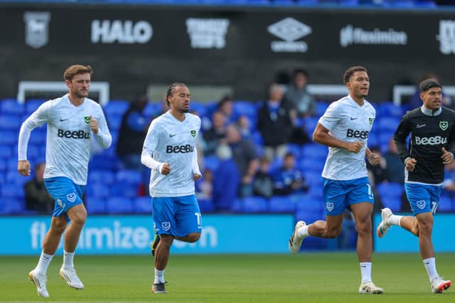 Marlon Pack (far right) and his fellow Pompey substitutes warm-up ahead of the 2-1 defeat  at Ipswich. It would be a match which sent a reminder of the midfielder's talents. Picture: Jez Tighe/ProSportsImages