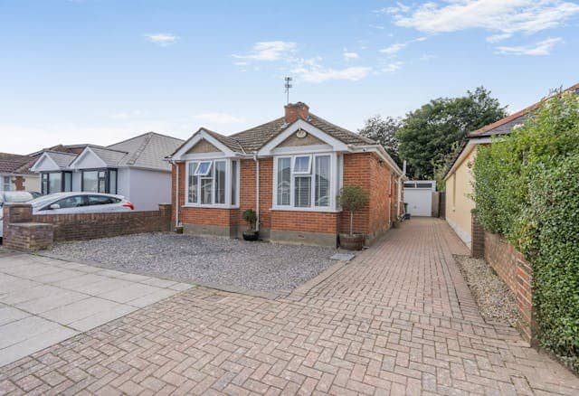 The property has driveway parking and a detached garage