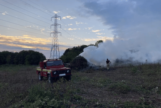 Firefighters extinguishing a bonfire near Portchester.