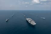 Aerial image of the Carrier Strike Group during Ex BERSAMA LIMA 2025 off the Malaysian coast, with HMS Prince of Wales at the helm.