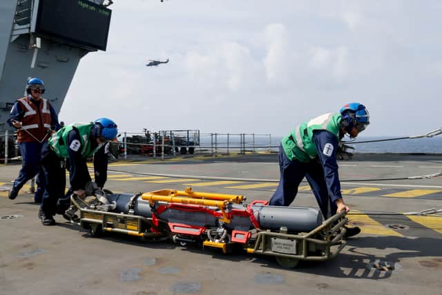 A Wildcat Helicopter from 815 Naval Air Squadron, currently embarked on the Norwegian Frigate HNoMS Roald Amundsen, lands on UK Carrier HMS Prince of Wales to embark a Sea Venom medium-weight anti-ship missile.