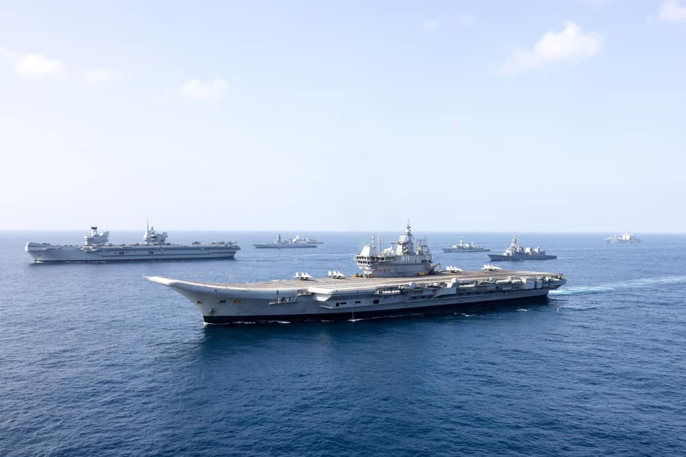 HMS Prince of Wales (left) forming up alongside INS Vikrant (front) during Exercise Konkan. The Carrier Strike Group is over halfway through the Operation Highmast deployment. She is passing through the Red Sea as Operation Highmast near its end.