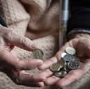 An elderly person looks at cash at home. Winter Fuel Payments for 2025/26 will start arriving in November, with most paid by December (Photo: Matt Cardy/Getty Images)