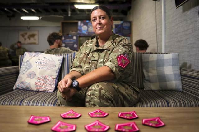 Petty Officer Emma Dell-Elsey with the custom made pink patches.