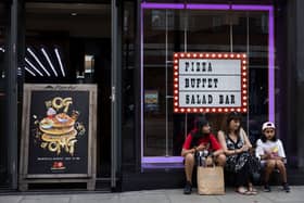 A family sit outside Pizza Hut on Oxford Street in London. The chain's UK dine-in business has entered administration, putting 68 restaurants at risk of closure (Photo: Dan Kitwood/Getty Images)