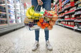 A woman holds a shopping basket of groceries. Asda is opening nine new Express convenience stores this week across London and the UK (Photo: Matthew Horwood/Getty Images)