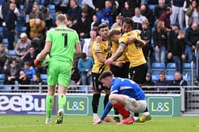 The Stoke players celebrate following Makenzie Kirk's crucial second-half miss in front of the Fratton End