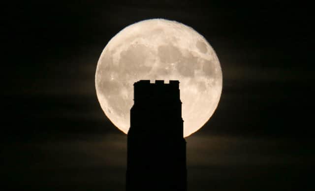 A full beaver moon rising behind St Michael's Tower on Glastonbury Tor in 2017