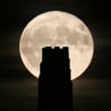 A full beaver moon rising behind St Michael's Tower on Glastonbury Tor in 2017