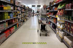 A man shops at a Waitrose supermarket in London. The supermarket has launched its new Little Treats rewards nationwide for My Waitrose members (Photo: HOLLIE ADAMS/AFP via Getty Images)