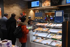 People queue at a counter inside a Greggs bakery in central London. The bakery chain has launched a new smaller 'Bitesize' store format for busy locations (Photo: JUSTIN TALLIS/AFP via Getty Images)