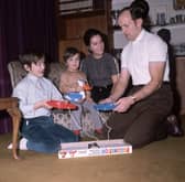 British boxer Henry Cooper plays the game frustration, at home with his family, in 1971