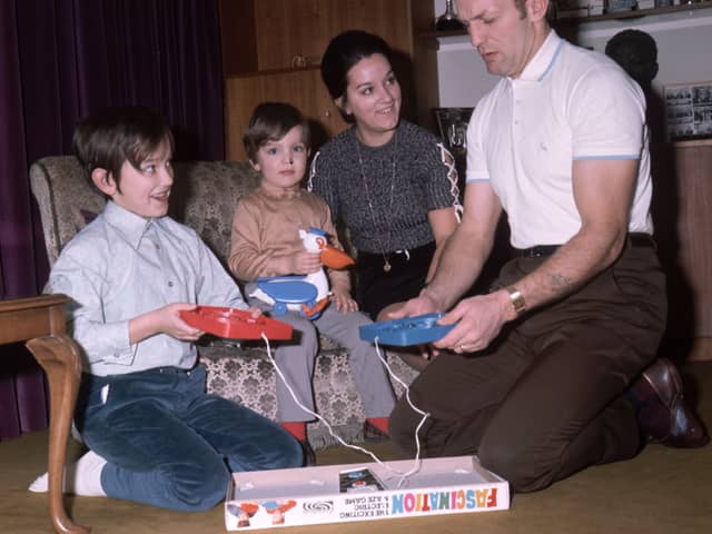 British boxer Henry Cooper plays the game frustration, at home with his family, in 1971