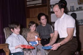 British boxer Henry Cooper plays the game frustration, at home with his family, in 1971