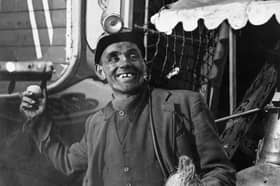 A miner tries his luck at the coconut shy at the Good Friday Fair in Conisbrough, South Yorkshire, in 1955