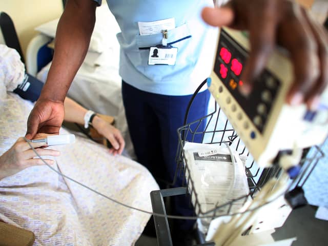 A nurse tends to recovering patients on a general ward at The Queen Elizabeth Hospital in Birmingham. Around 18,000 NHS staff in England are set to lose their jobs under major restructuring plans (Photo: Christopher Furlong/Getty Images)