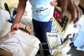 A nurse tends to recovering patients on a general ward at The Queen Elizabeth Hospital in Birmingham. Around 18,000 NHS staff in England are set to lose their jobs under major restructuring plans (Photo: Christopher Furlong/Getty Images)