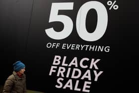 A woman walks past a Black Friday sale sign on Oxford Street. Black Friday has stretched into 'Black November', making real bargains harder to spot (Photo: Jack Taylor/Getty Images)