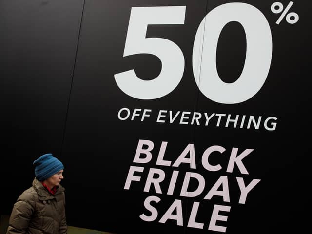 A woman walks past a Black Friday sale sign on Oxford Street. Black Friday has stretched into 'Black November', making real bargains harder to spot (Photo: Jack Taylor/Getty Images)