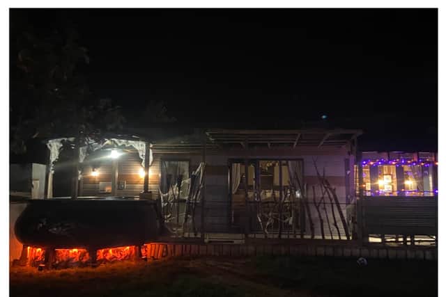 The hot tub cauldron and caravan at night. (Photo: Isabella Boneham)
