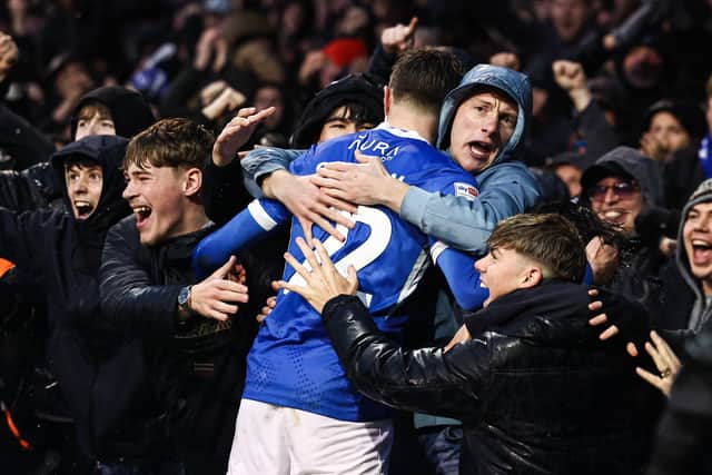 Zak Swanson celebrates his opener against Millwall with the fans in the North Stand