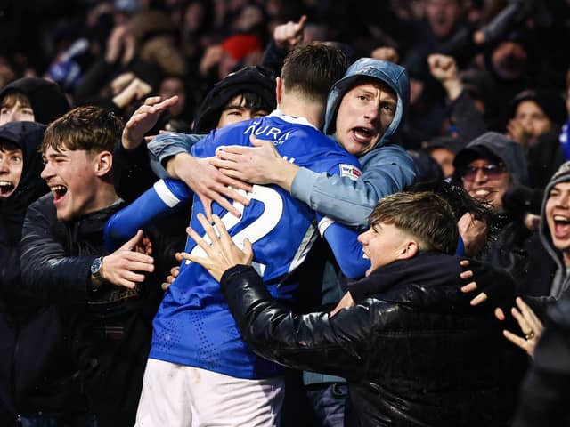 Zak Swanson celebrates his opener against Millwall with the fans in the North Stand