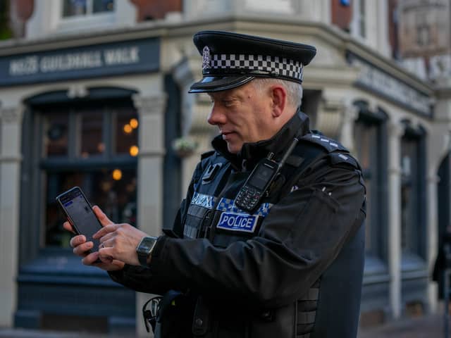 Pictured: Chief Inspector, Marcus Cator with the UKPAC app on his phone at Guildhall Walk, Portsmouth