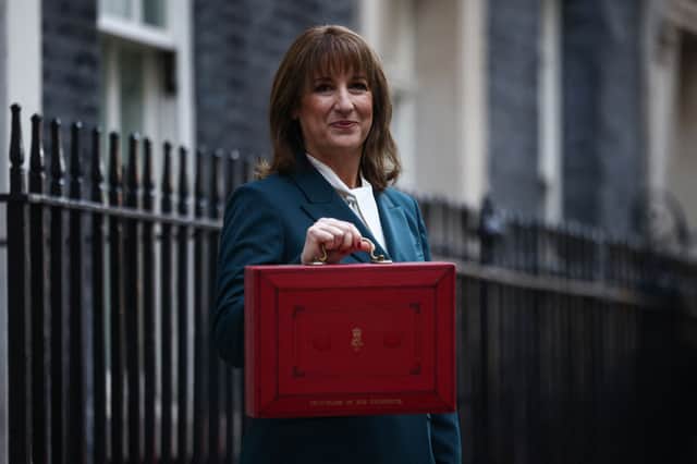 Britain's Chancellor of the Exchequer Rachel Reeves poses with the red Budget Box as she leaves 11 Downing Street, in central London on November 26, 2025, to present the government's annual Budget to Parliament