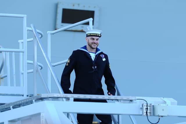 Pictured is: Leading Hand Joseph Mellor was the first sailor to step ashore from HMS Prince of Wales.