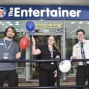 Mike Dawes, store manager, Charley Woodley, assistant manager and Alex Dickenson, store supervisor, celebrate the opening of The Entertainer on Friday, December 5.