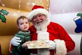 Christmas magic at HMS Sultan: Father Christmas greets delighted children at the naval engineering base, bringing festive joy to military families.