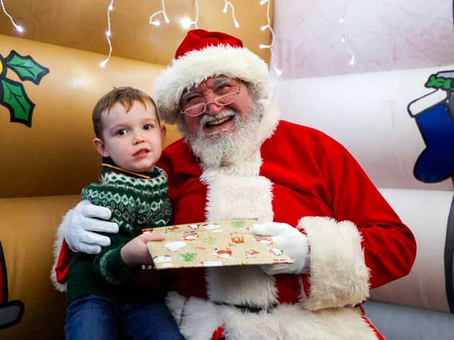 Christmas magic at HMS Sultan: Father Christmas greets delighted children at the naval engineering base, bringing festive joy to military families.