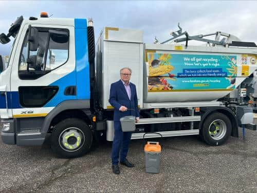 Cllr Ian Bastable with new food waste collection vehicles and caddies to be delivered to Fareham Borough Council residents