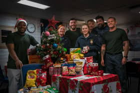 Personnel aboard HMS Medway receiving Christmas presents and donations from the RNRMC.