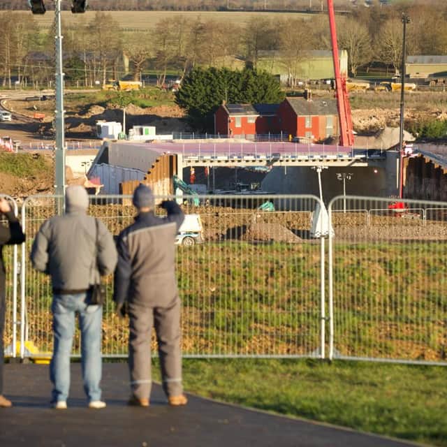 Onlookers view the progress of the works on the M27 junction 10 work.