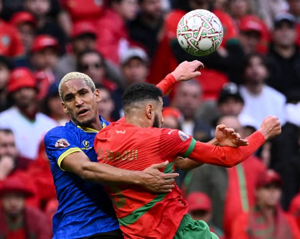 Haji Mnoga challenges Morocco defender Noussair Mazraoui on Sunday at the Africa Cup of Nations. Picture: SEBASTIEN BOZON / AFP via Getty Images
