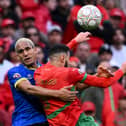 Haji Mnoga challenges Morocco defender Noussair Mazraoui on Sunday at the Africa Cup of Nations. Picture: SEBASTIEN BOZON / AFP via Getty Images