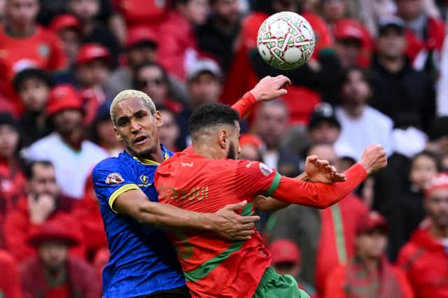 Haji Mnoga challenges Morocco defender Noussair Mazraoui on Sunday at the Africa Cup of Nations. Picture: SEBASTIEN BOZON / AFP via Getty Images