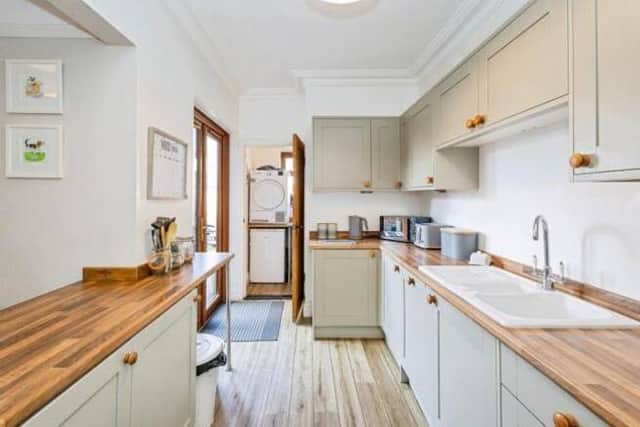 A well-equipped kitchen leads into a practical utility area