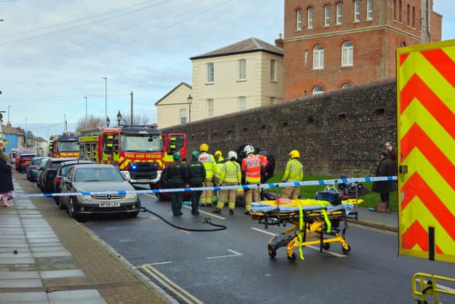 Firefighters remove the trapped driver in Cromwell Road