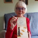 Elizabeth Salt, 79 of Lichfield, with her autograph book stuffed full of 60s icons that she collected as teenager in Portsmouth.