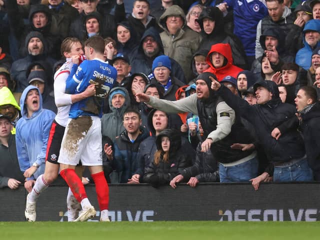 12 supporters have been named and shamed for disorder at the South Coast Derby between Portsmouth and Southampton at Fratton Park. Pictured: Zak Swanson and Flynn Downes clash in the incident the Pompey man believes inspired his side's south-coast derby fightback with Southampton.