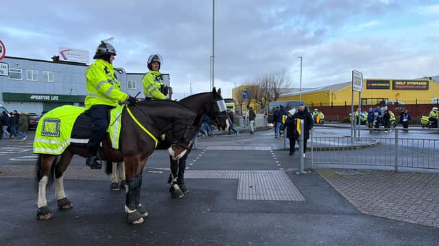 Heavy police presence around Fratton Park, including police horses