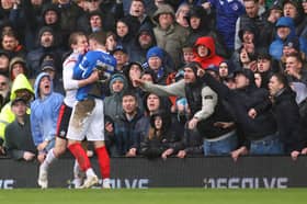 Zak Swanson grapples with Southampton Flynn Downes in Sunday's 1-1 draw - which also marked his 100th Pompey appearance. Picture: Charlie Crowhurst/Getty Images