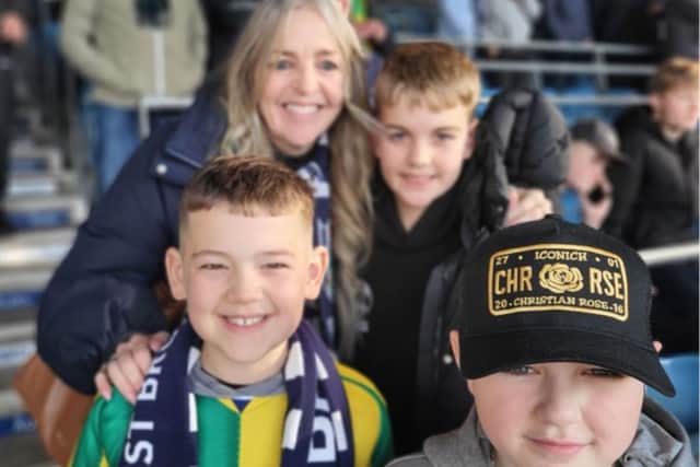 Dawn and George (back) pose for pictures with two young baggies fans - one of whom is called Astle in honour of Dawn's dad, Jeff Astle.